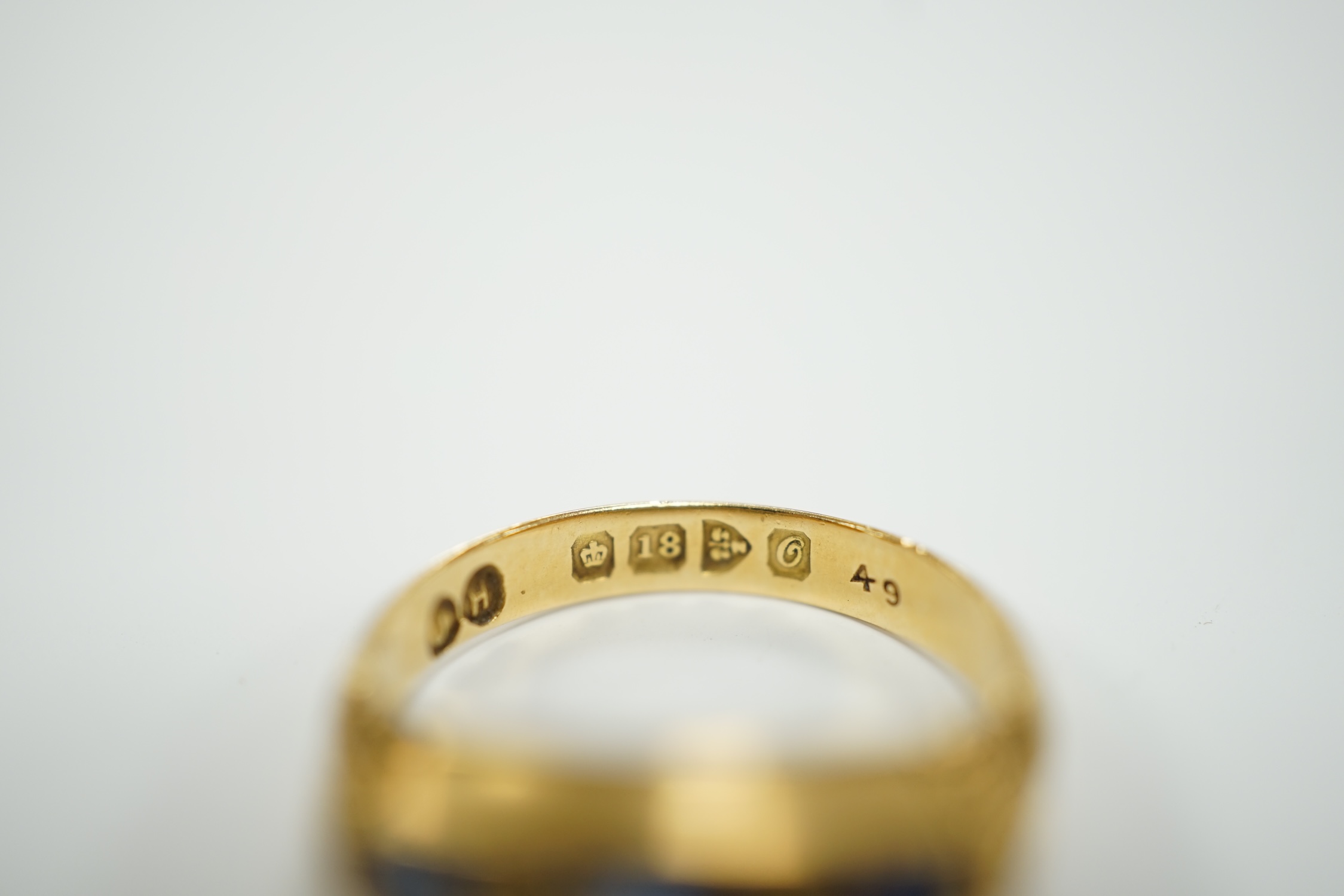A George V 18ct gold and three stone sapphire set ring, with diamond chip spacers, size K, gross weight 3.3 grams.